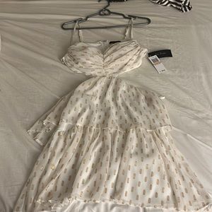 Cut out side/ back. Gold and just off white beautiful dress